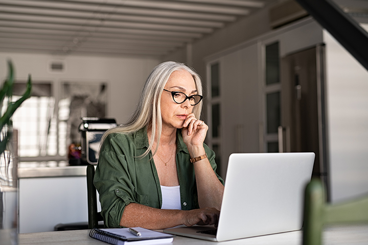 woman sitting in her home office working 