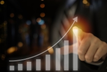 business financial indicator and the stock market investment growth in a bar chart growing on a visual touch screen