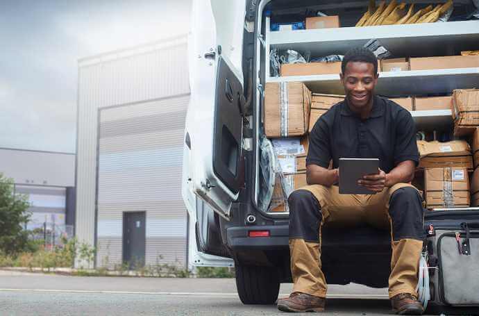 Man sitting in a truck of parcels Man sitting in a truck of parcels