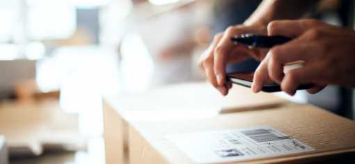 hands scanning a label on a package