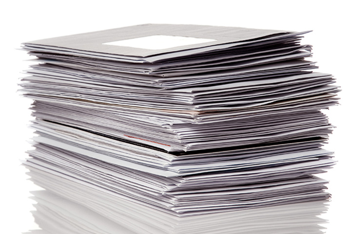 Stack of envelopes and office mail, representing postage meter use for high-volume mailing, postage processing, and mailroom efficiency.