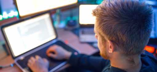 a guy programming on a laptop