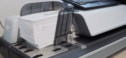 a stack of letters on a quadient equipment