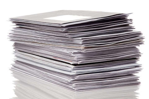 Stack of envelopes and office mail, representing postage meter use for high-volume mailing, postage processing, and mailroom efficiency.